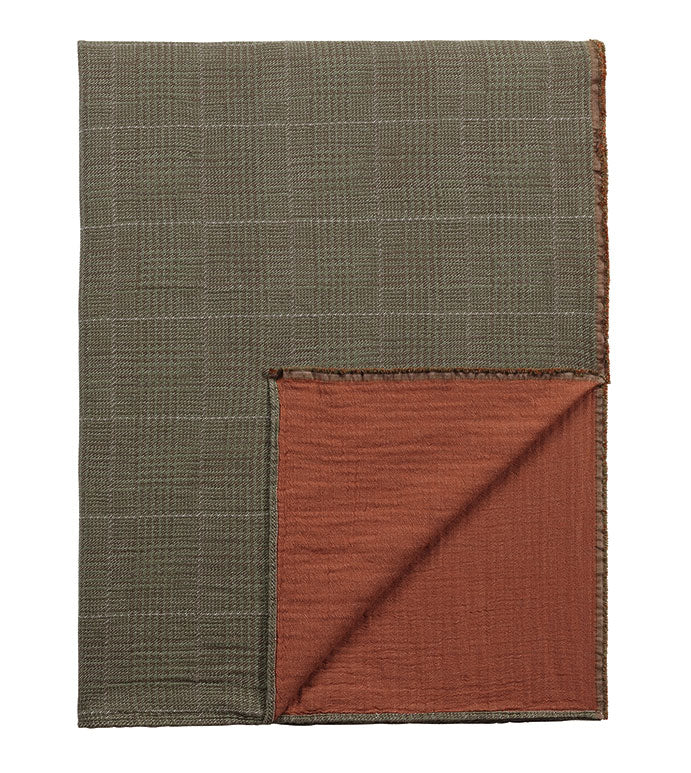 This cozy brown plaid throw, crafted from 100% cotton, offers both comfort and style. The throw is backed with a solid orange fabric for a bold contrast and features a charming frayed edge finish. It is machine washable for easy care, and custom options are available to suit your personal preferences.